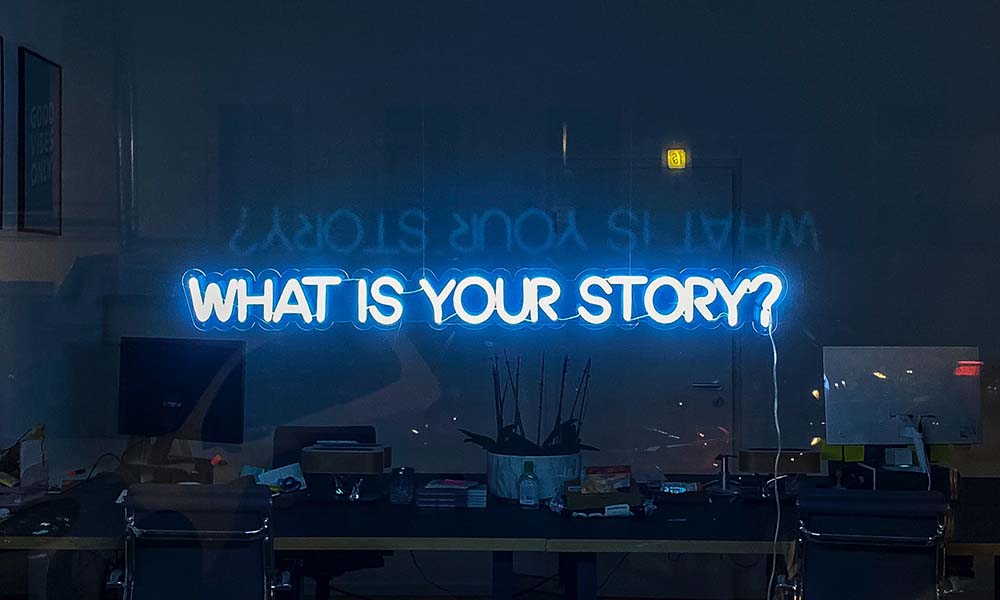 stockphoto blue neon sign what is your story