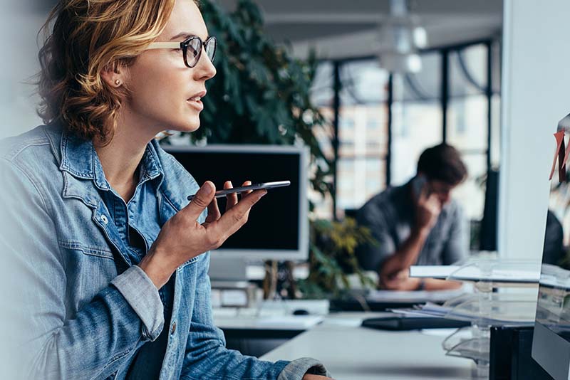 stockphoto woman on mobile phone at desk