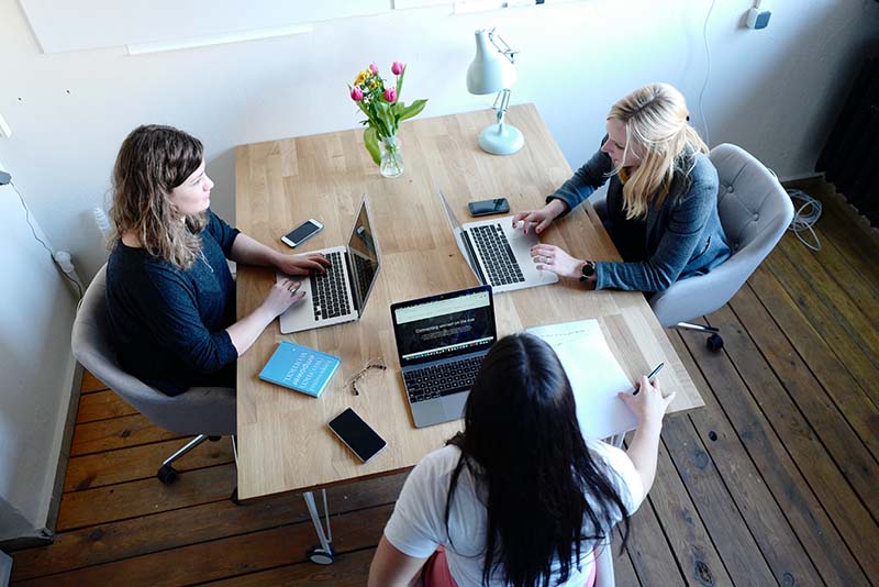 stockphoto three women on laptops at desk